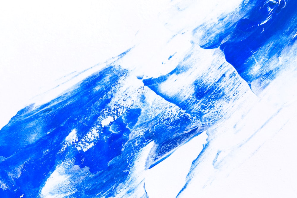 A diagonal slash of vibrant blue paint on a textured white background