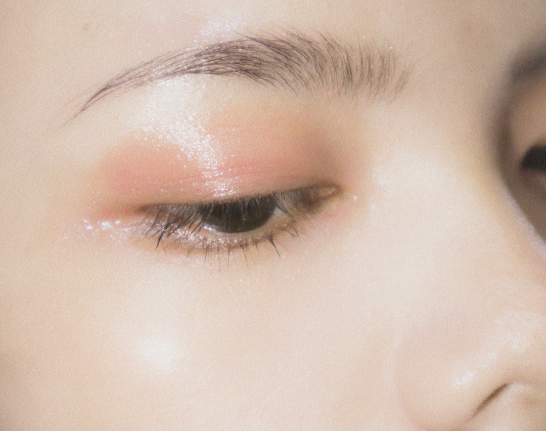 Close-up of a closed eye with soft pink shimmer eyeshadow