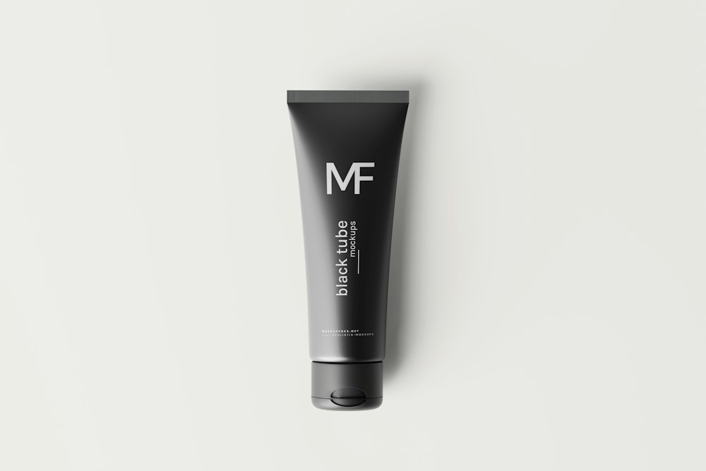 A black tube with white text reading "MF" and "black tube mockups" on a light background