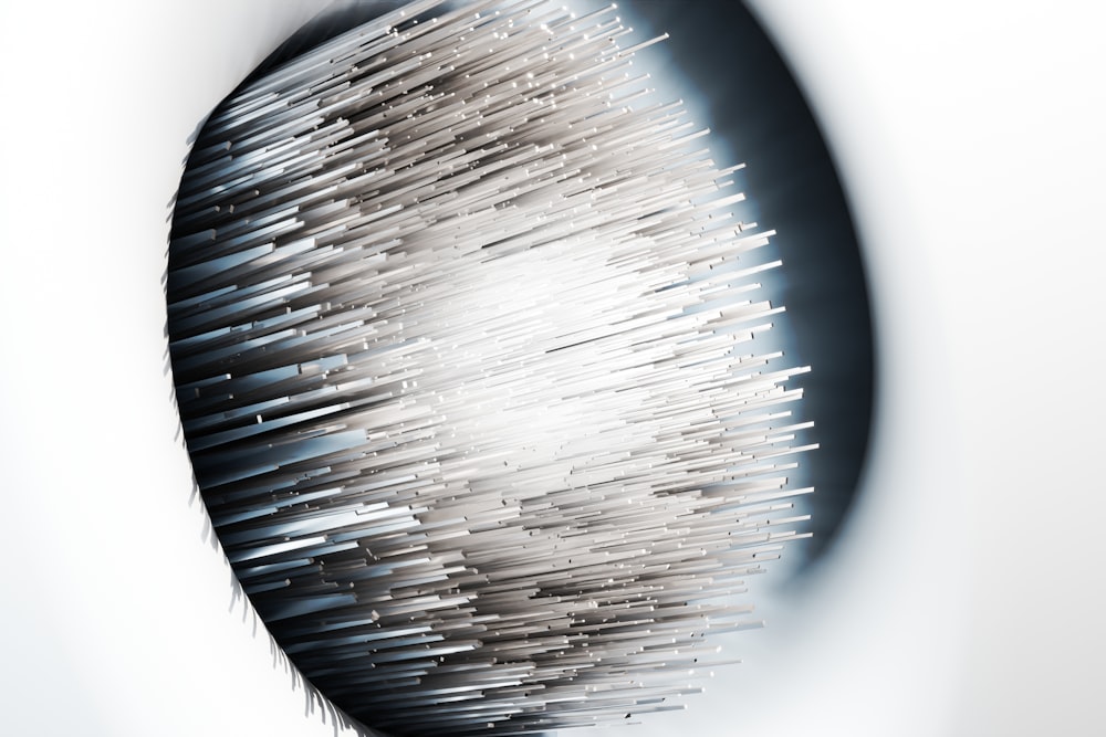 A dense cluster of metallic rods extends outward from a dark circular recess