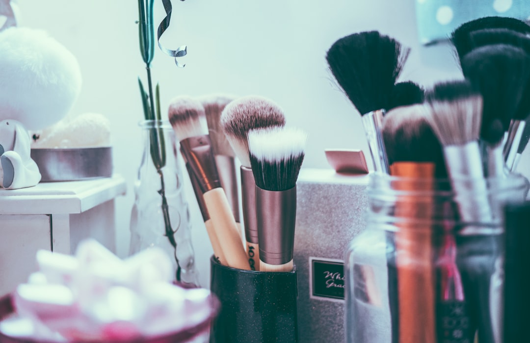 Makeup brushes standing in jars on a vanity