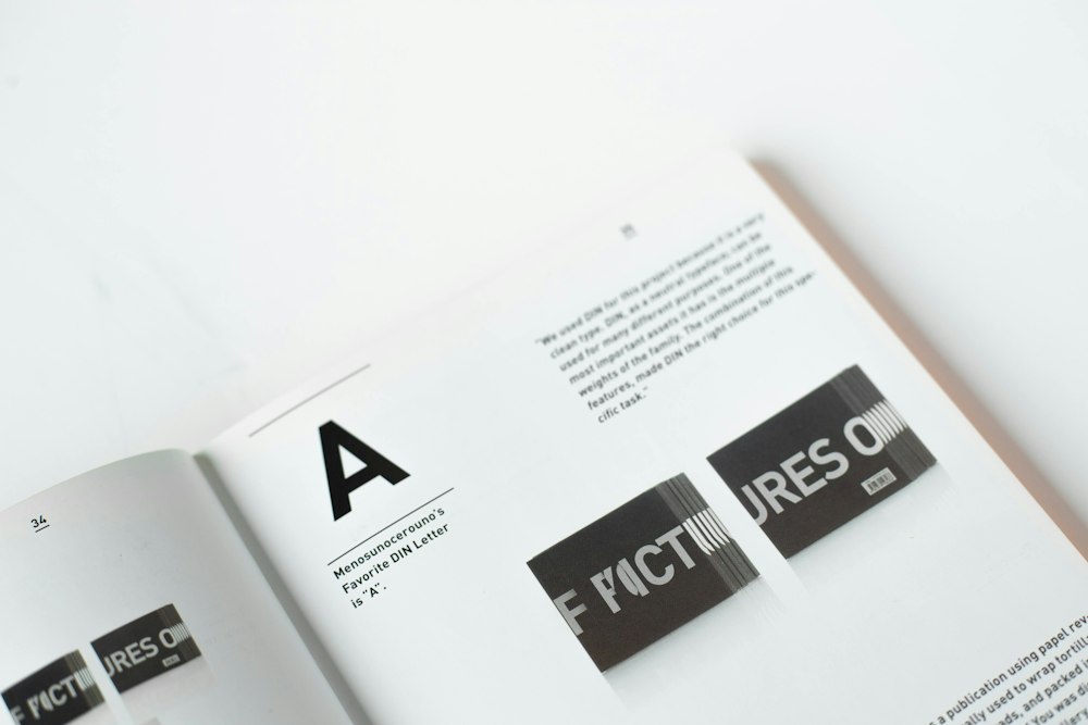 An open book with text and images on the page, including a large letter "A"